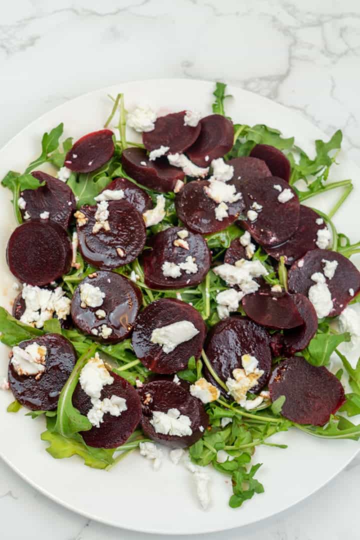 This Roasted Beets with Goat Cheese and Balsamic Salad is made with beets, walnuts, goat cheese, arugula, olive oil and vinegar.