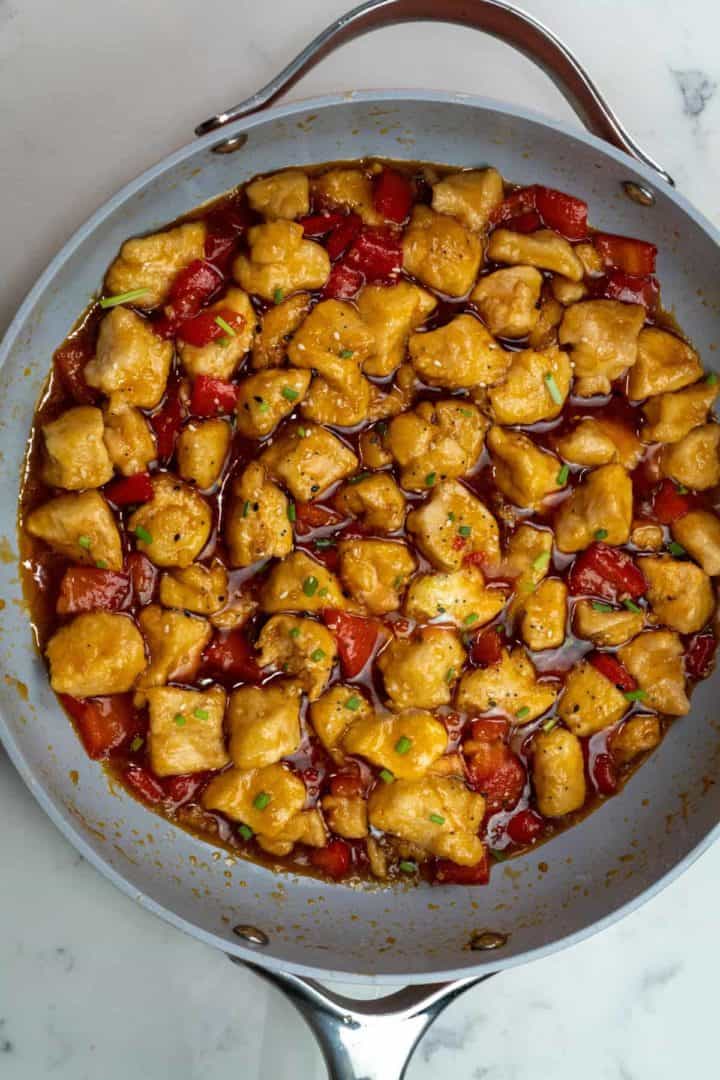 This Sweet and Sour Chicken Recipe is made with chicken, bell peppers, sugar, vinegar, ketchup, soy sauce, sesame oil, and maple syrup.
