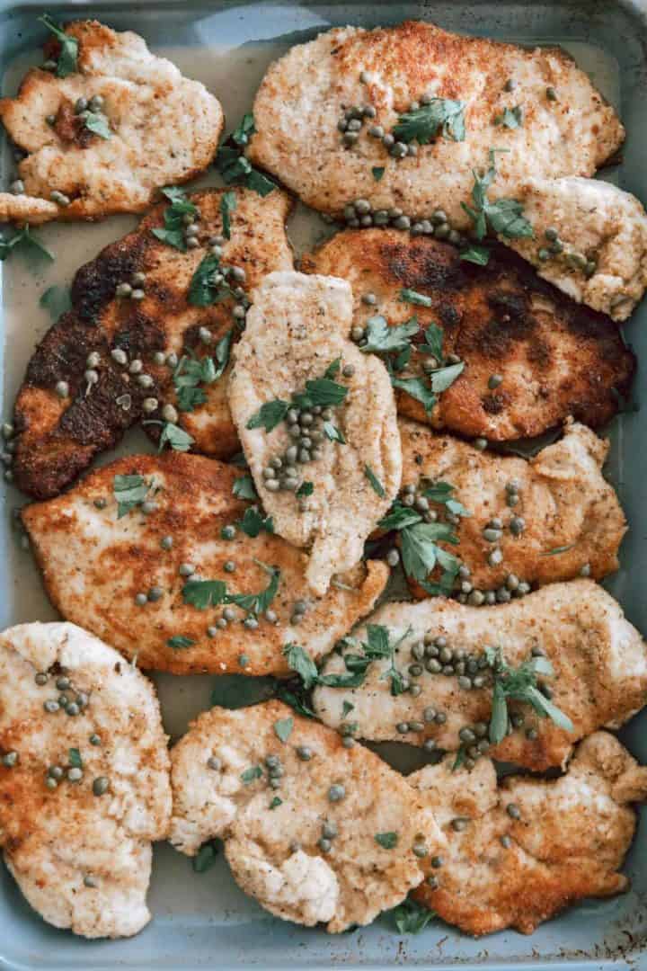 This Chicken Piccata Milanese is made with chicken breasts, flour, eggs, bread crumbs, capers, lemons, broth, and parsley.