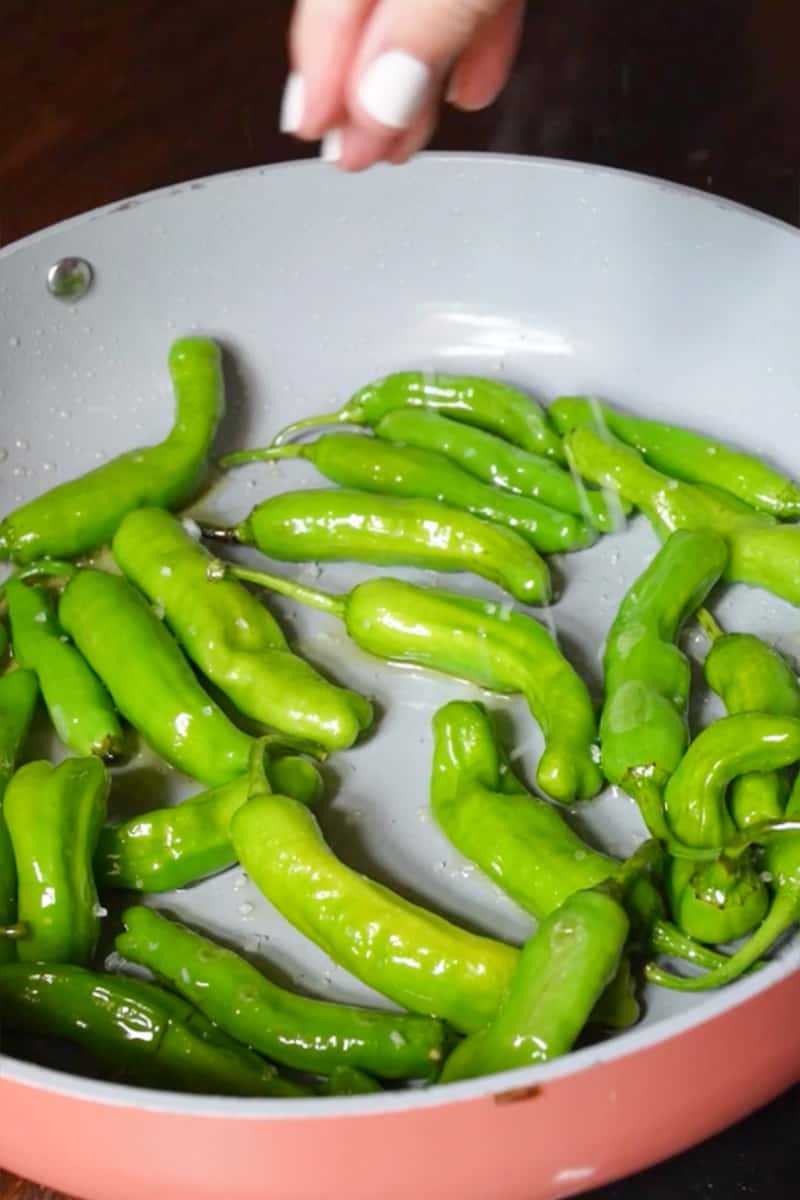 Carefully add the shishito peppers to the pan in a single layer. Make sure they are not overcrowded.