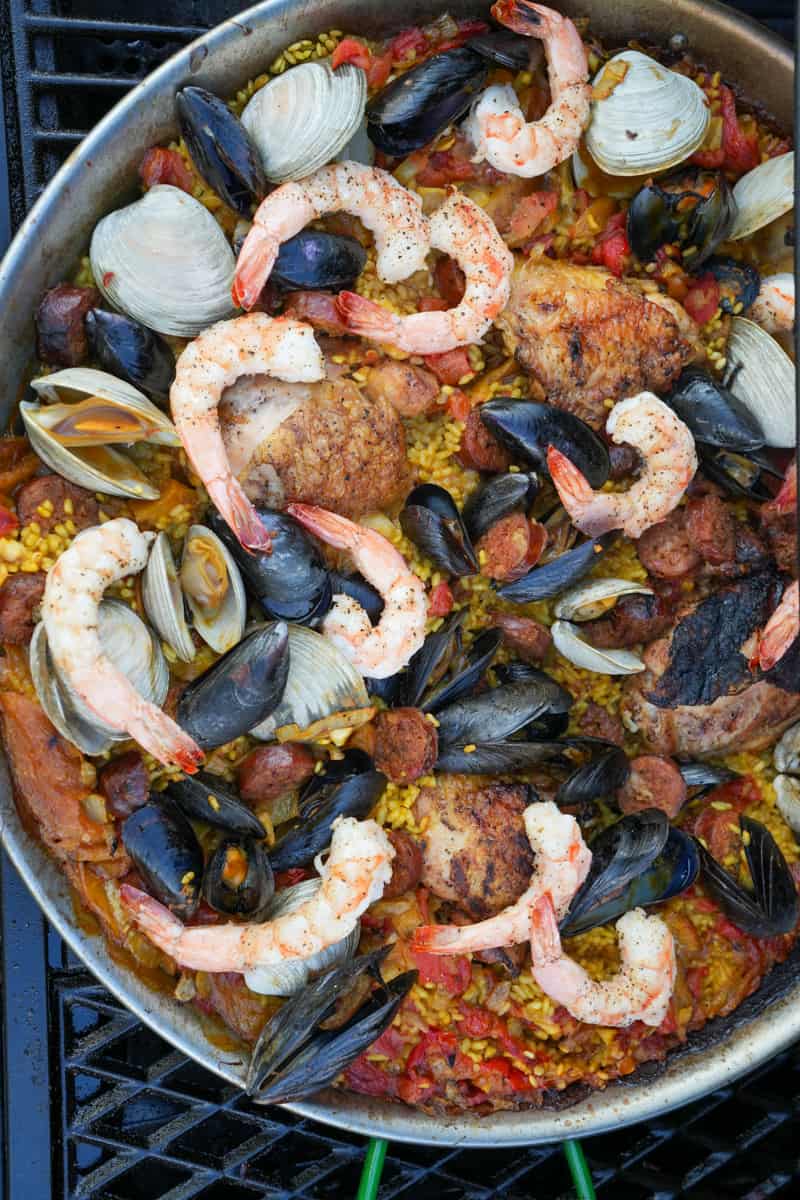 This Spanish Paella Recipe is made saffron, chicken legs, bomba rice, onion, tomato sauce, chorizo, shrimp, mussels, and clams.