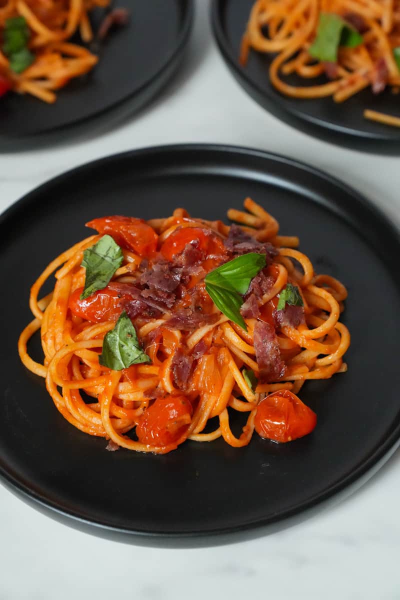 This Salami Spaghetti Recipe is made with spaghetti, salami, onion, garlic, cherry tomatoes, basil and simmered to perfection.