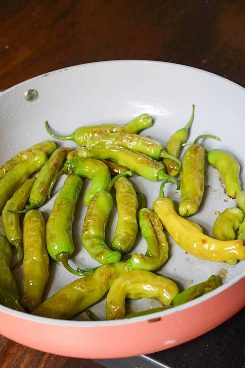 Sauté the peppers, stirring occasionally, until they blister and char slightly, about 5-7 minutes. The peppers should be tender and have a slight char on the outside.