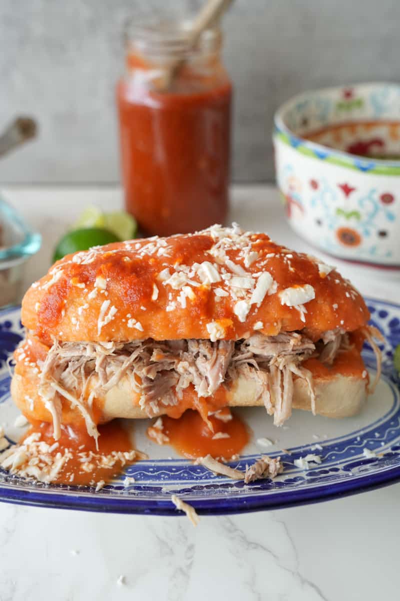 This Tortas Ahogadas Recipe is made with carnitas, refried beans, hot sauce, hard rolls and dipped in a tomato sauce.