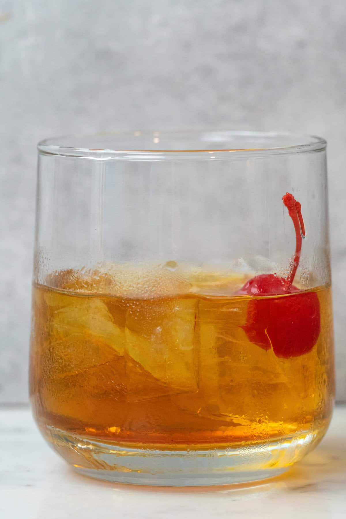 To make this Manhattan Drink, you mix Bourbon, Vermouth, and Bitters and garnish with a maraschino cherry or orange peel.