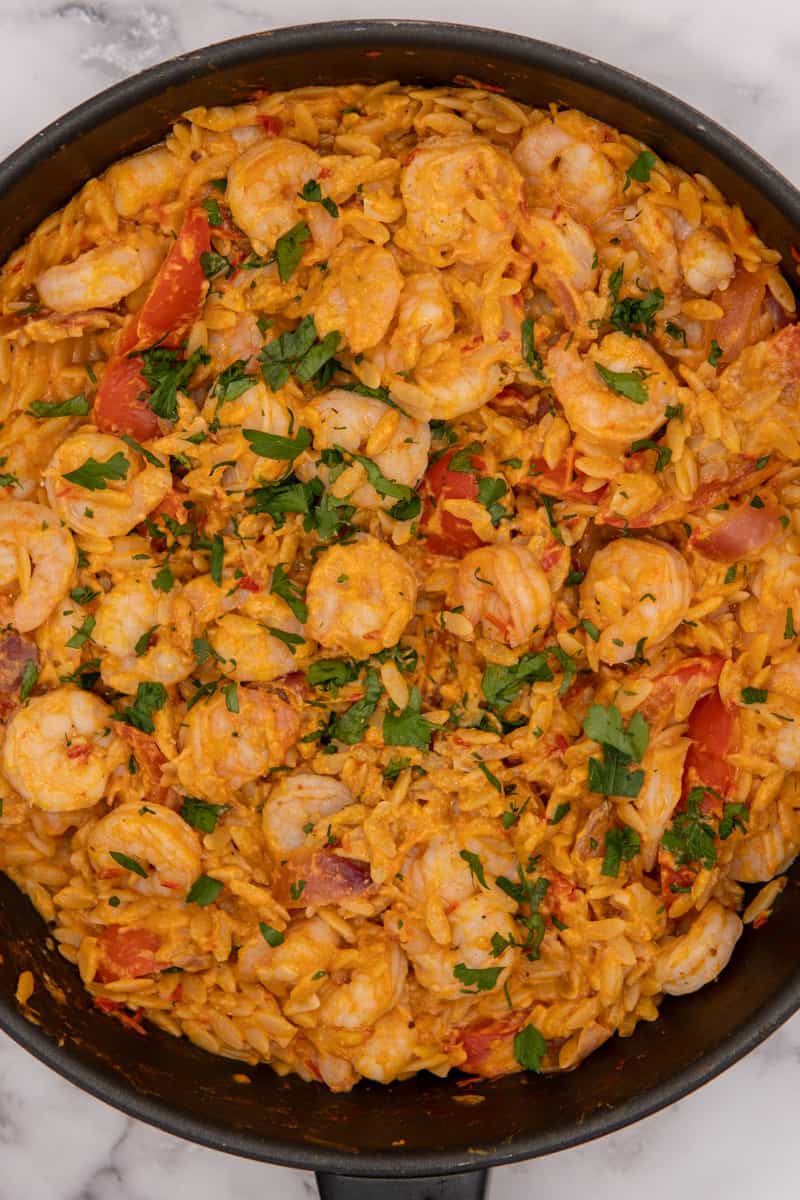 This One-Pot Shrimp Orzo Recipe with Harissa and Tahini is made with shrimp, onion, bell pepper, orzo, white wine, harissa and tahini.