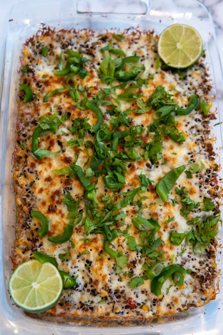 This Taco Bake Recipe is made with beef, diced tomatoes, black beans, corn, onions, bell peppers, seasonings, and lots of cheese.