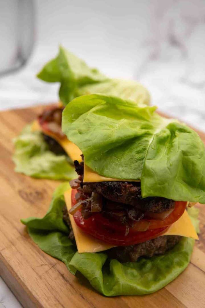 This Lettuce Burger Recipe is made with caramelized onions, ground beef, Worcestershire sauce, cheese, butter lettuce, and tomato.