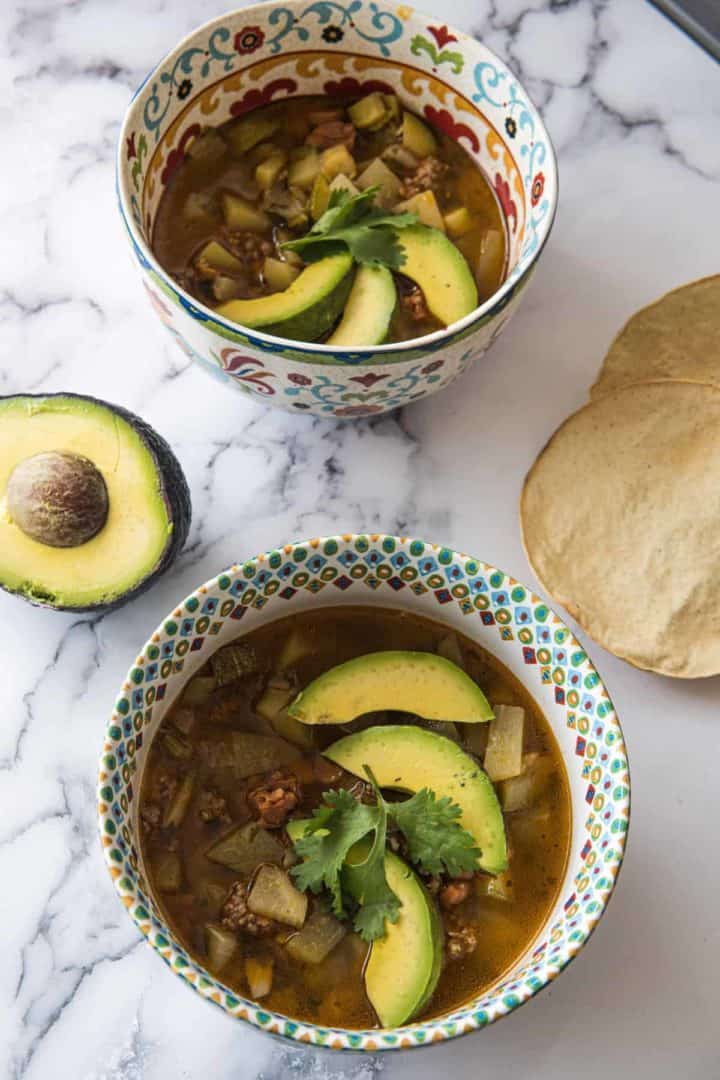 This Zucchini Beef Soup Recipe is made with onion, carrots, zucchini, spanish chorizo, ground beef, tomato, and cilantro.