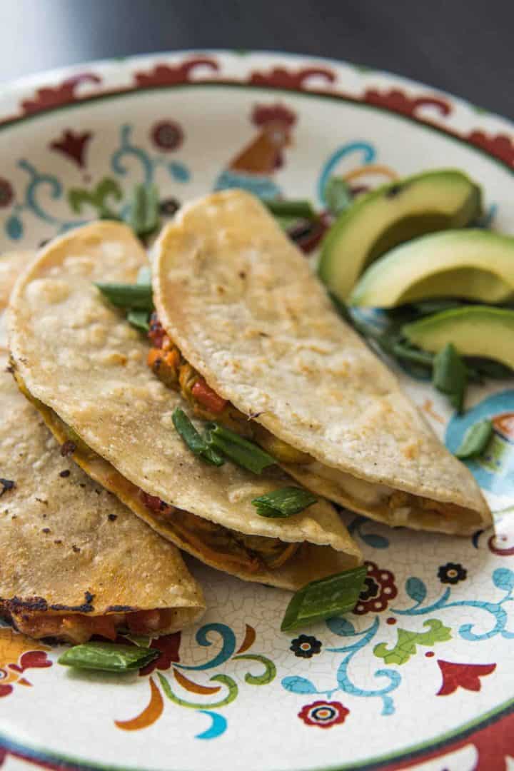 This Squash Blossom Quesadilla Recipe (Quesadillas de Flor de Calabaza) is made with zucchini blossoms, cheese, garlic, and corn tortillas.