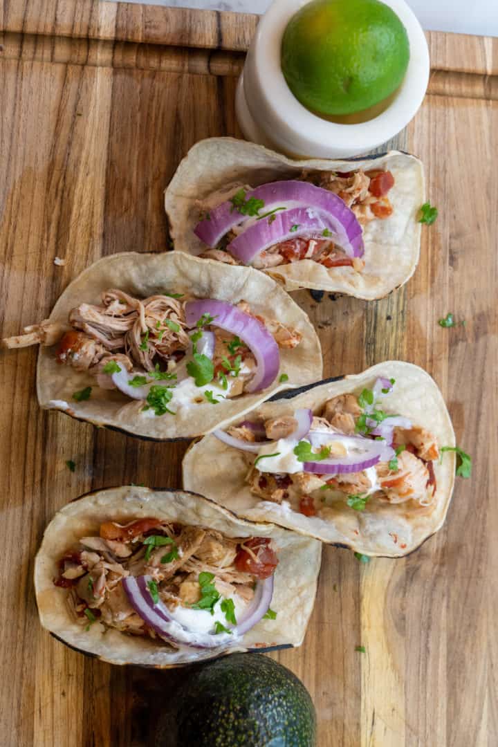 This Chicken Tinga Instant Pot are made with chicken breast, garlic, onion, chipotle peppers, tomatoes, and tortillas.