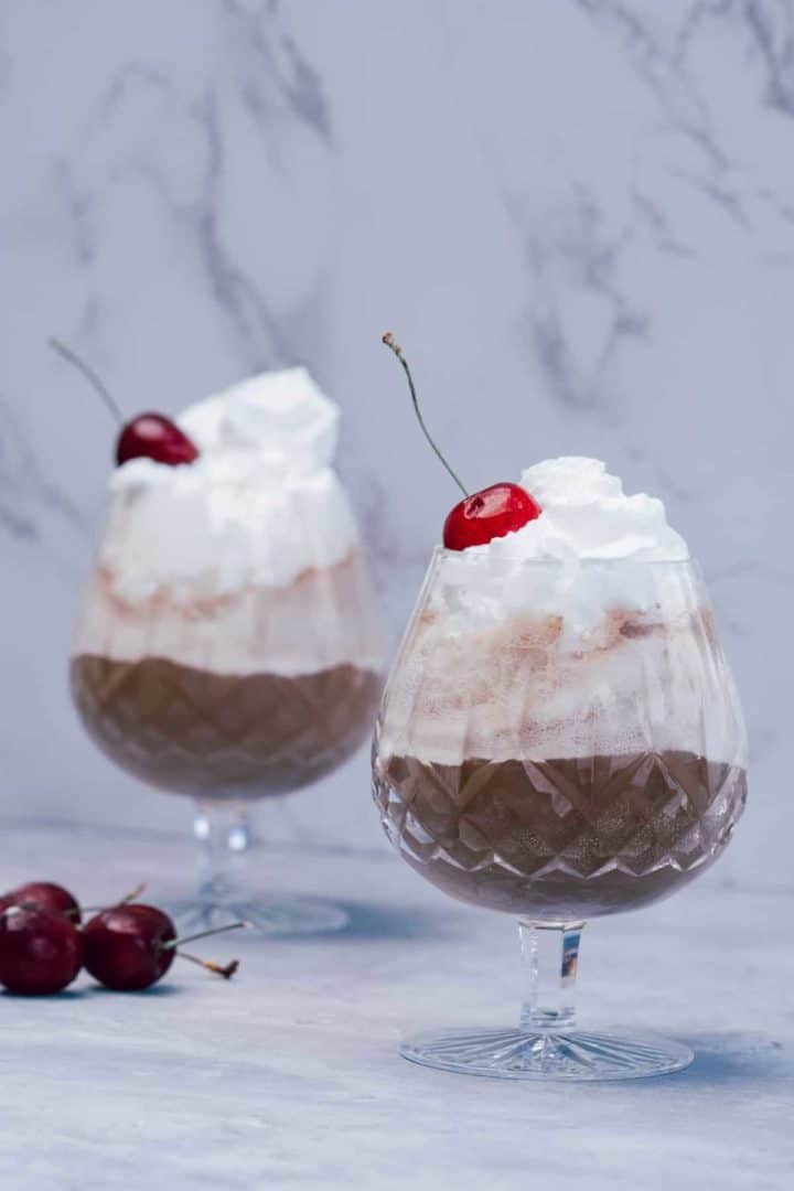 This Root Beer Float Recipe is made with vanilla ice cream, root beer, whipped cream and fresh or maraschino cherries.