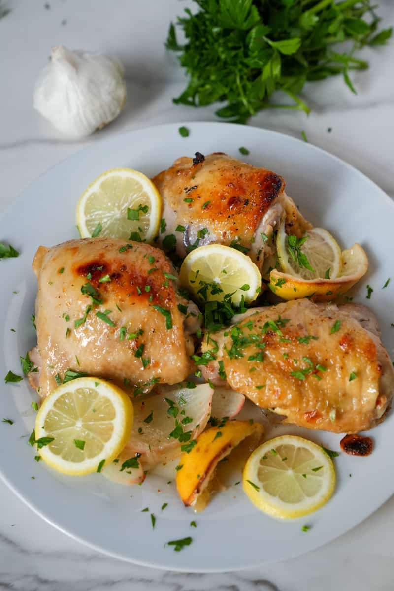 This Italian Dressing Chicken Recipe is made with bone in chicken thighs, a bottle of italian dressing, onions, and lemons.