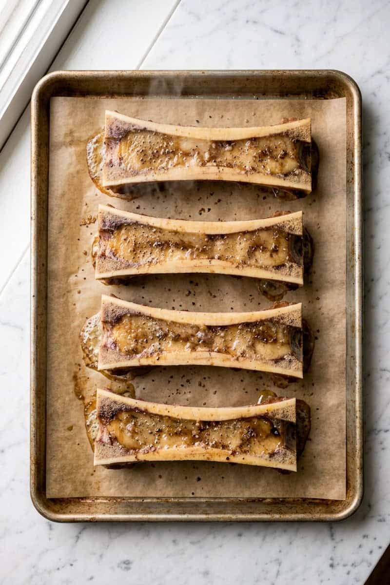 Marrow bones roasting on an oven tray