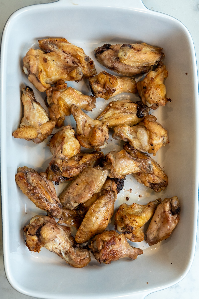 How to Air Fry Frozen Chicken Wings is simple: defrost the chicken in the air fryer, season, then air fry again and toss in a yummy sauce.