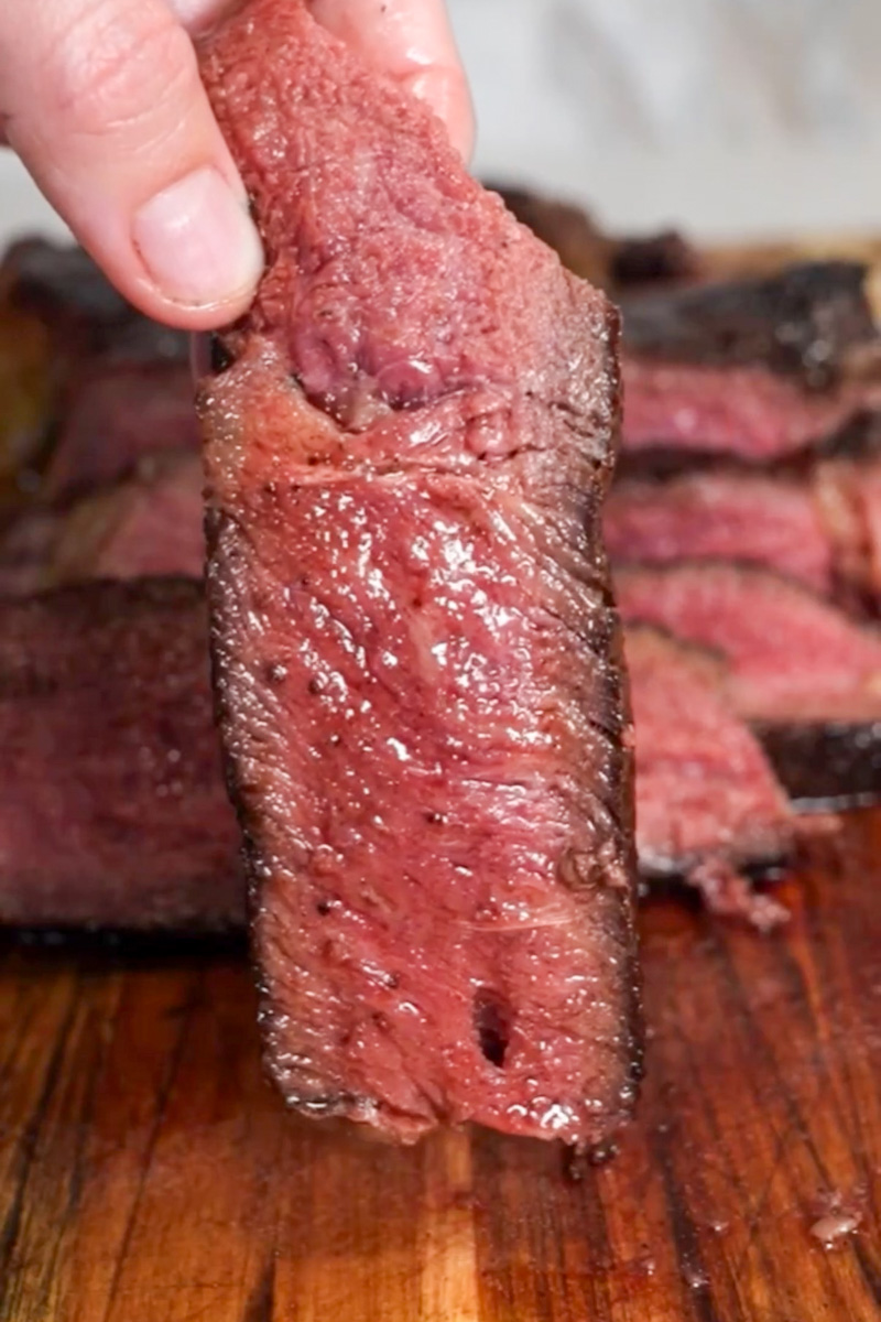 Sliced reverse-seared steak topped with shallot vermouth pan sauce