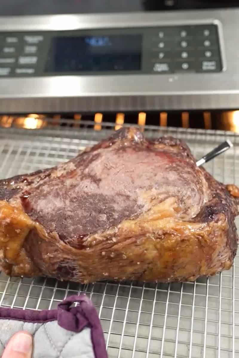 Thick steak developing a browned crust in a cast-iron skillet