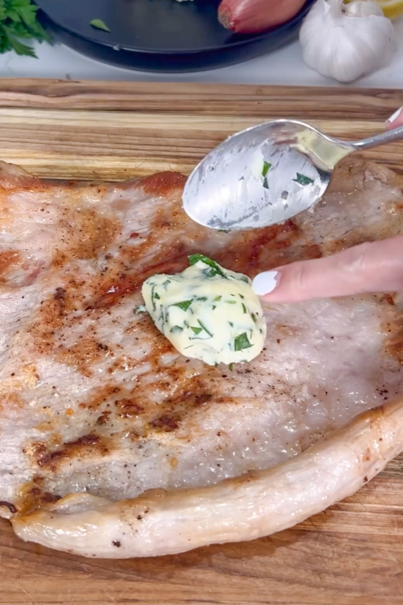 Herb butter melting over a pan-seared steak