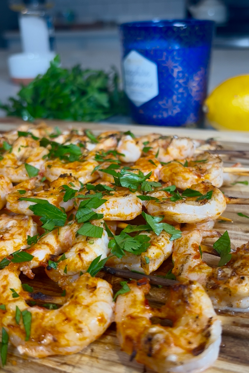 Grilled shrimp skewers brushed with lemon-harissa marinade