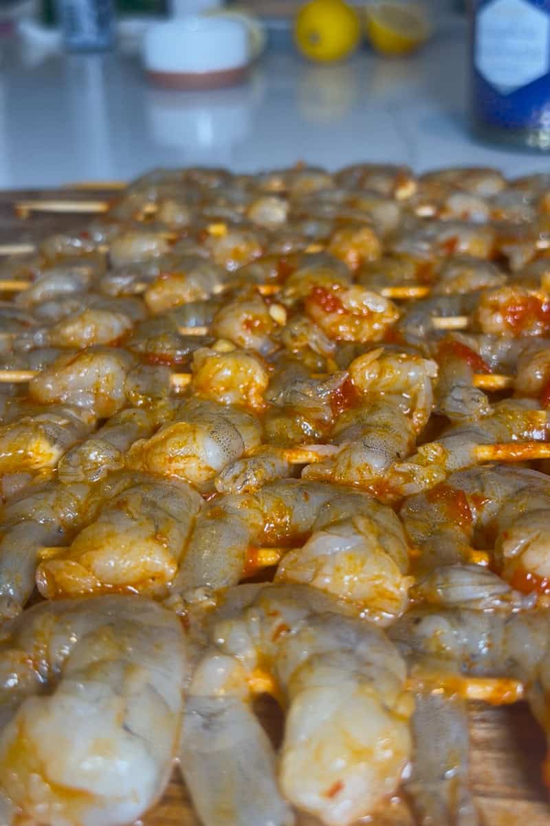Grilled shrimp skewers brushed with lemon-harissa marinade