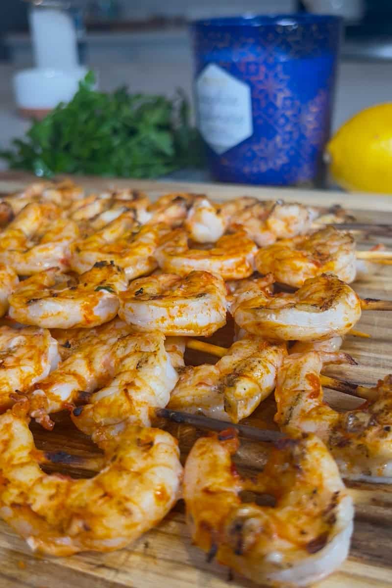 Grilled shrimp skewers brushed with lemon-harissa marinade