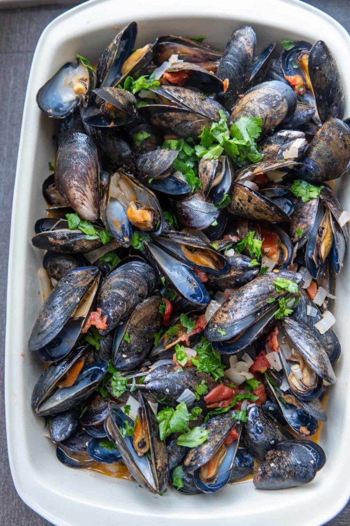 These Mussels Marinara Recipe is made with mussels, white wine, diced tomato, onion, garlic and parsley and cooked to perfection.