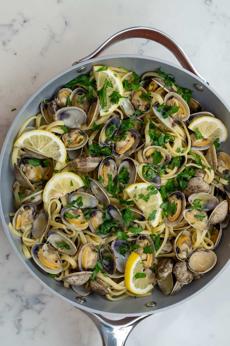 This Clam Spaghetti with White Wine is made with manila clams, butter, red pepper flakes, garlic, white wine, lemons, and parsley.