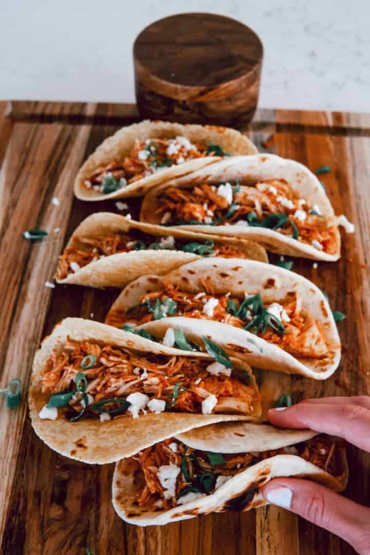 These Chicken Tinga Instant Pot are made with chicken breast, garlic, onion, chipotle peppers, tomatoes, and tortillas.