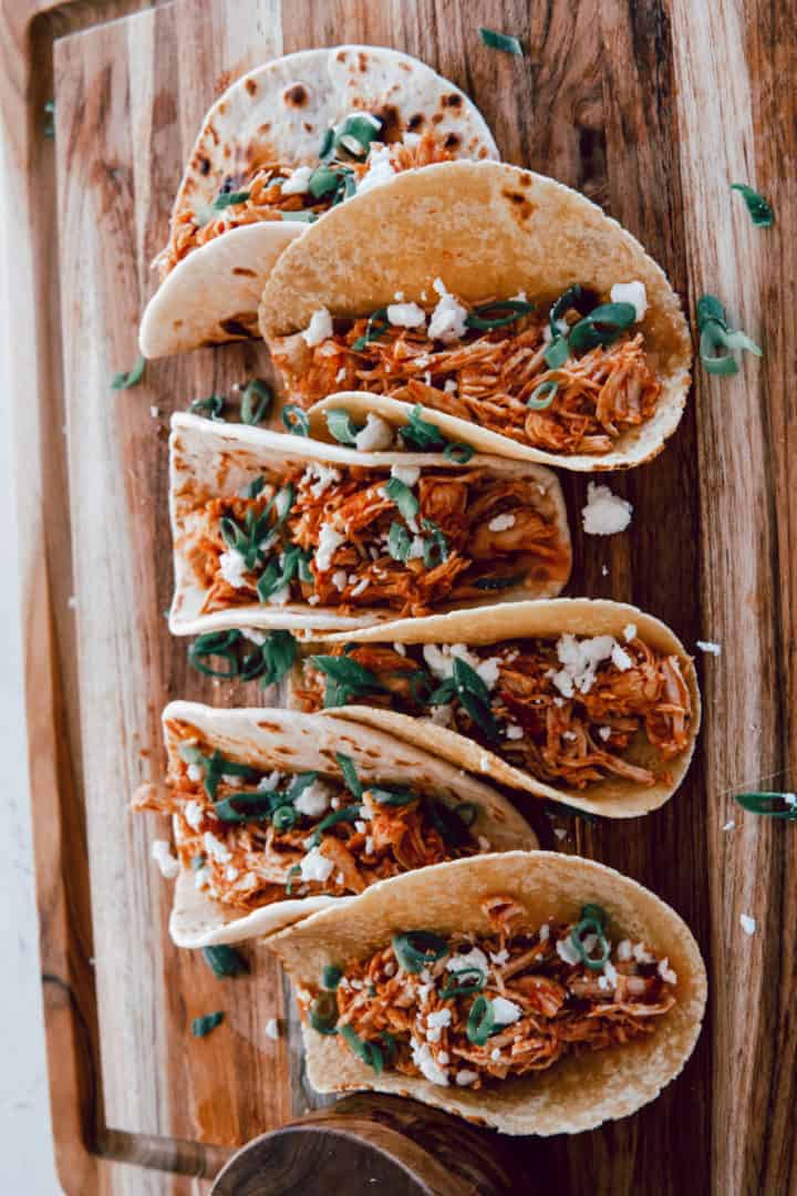 These Chicken Tinga Instant Pot are made with chicken breast, garlic, onion, chipotle peppers, tomatoes, and tortillas.