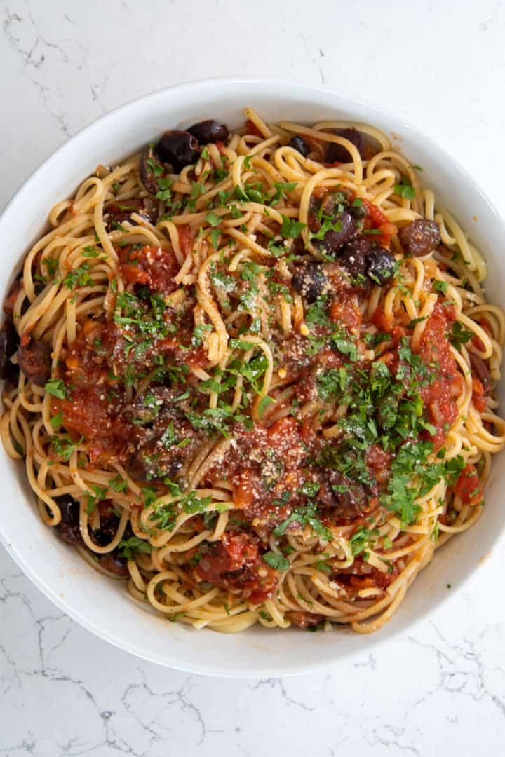 This Vegan Puttanesca is made with onion, garlic, white wine, tomatoes, capers, olives, and topped on al dente spaghetti.