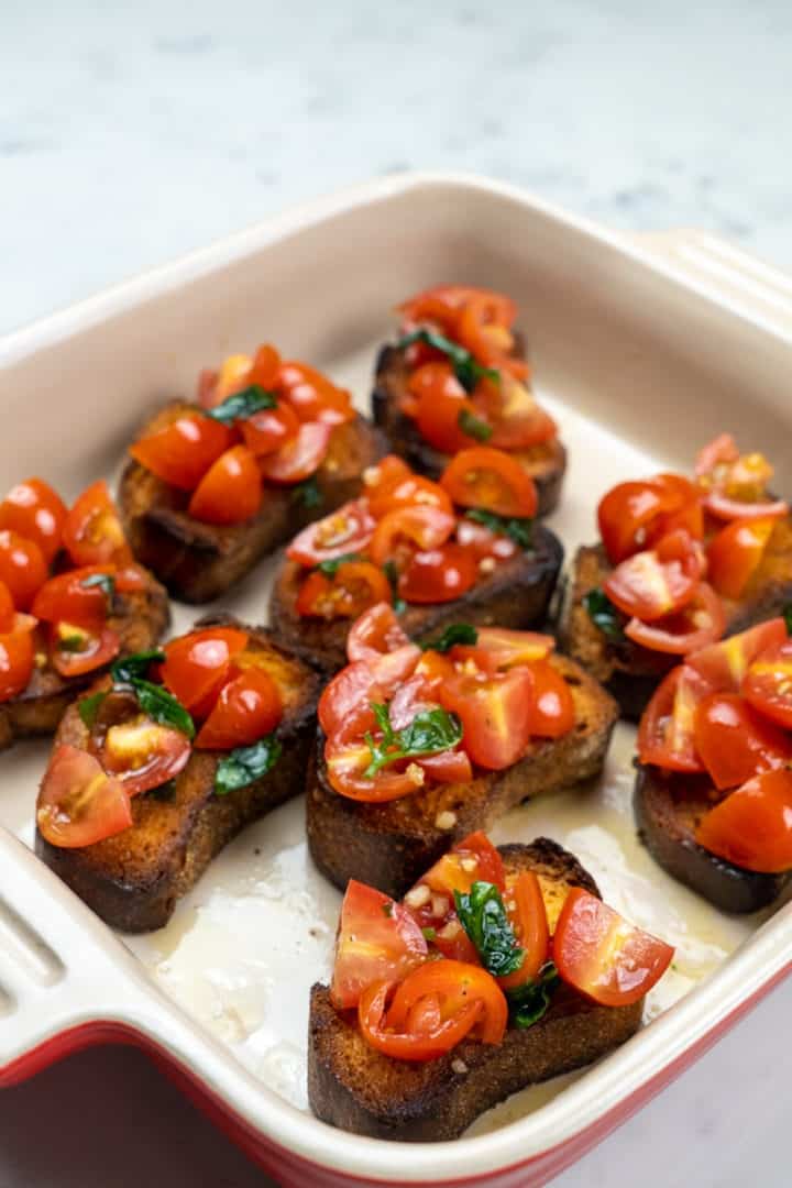 This Bruschetta Pomodoro is made with cherry tomatoes, basil, garlic, olive oil, salt, balsamic vinegar and served on toasted bread.