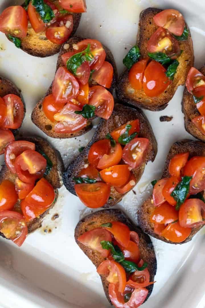 This Bruschetta Pomodoro is made with cherry tomatoes, basil, garlic, olive oil, salt, balsamic vinegar and served on toasted bread.