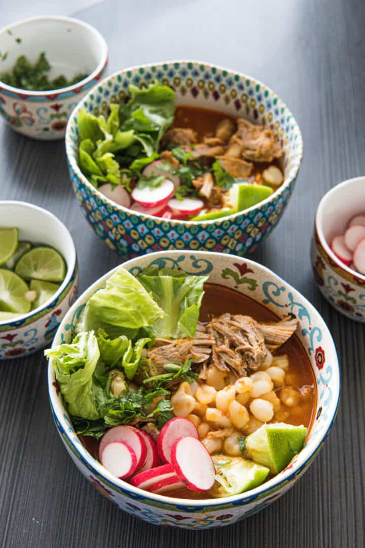 This Pozole Recipe is made with pork shoulder, chiles anchos, chiles guajillos, onion, garlic, oregano and hominy.