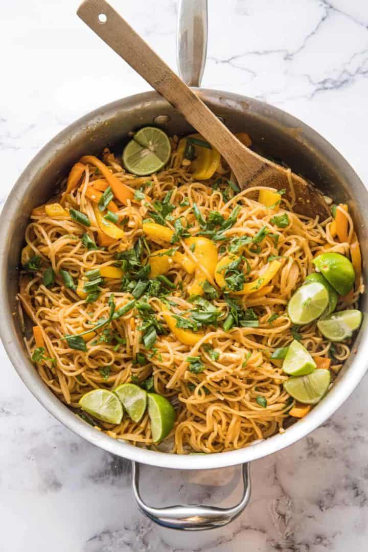 This Vegetable Pad Thai Recipe is made with rice noodles, garlic, ginger, eggs, bell pepper, peanuts, scallions, limes and cilantro.