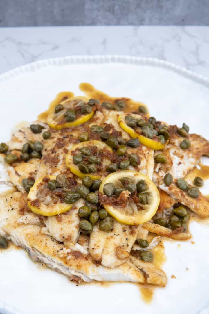 This Sautéed Flounder Lemon Capers dish is made with flounder, flour, olive oil, butter, lemons, and capers.