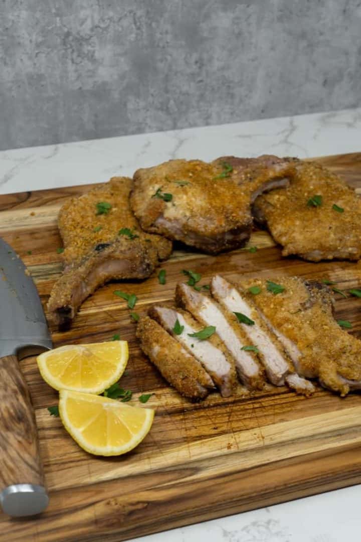 These Shake and Bake Pork Chops (Air Fryer and Oven) are made with pork chops, paprika, parmesan, thyme, and served with lemon wedges.