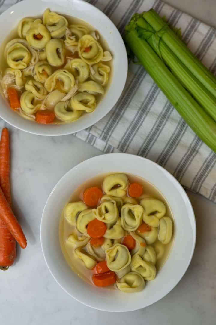 This Tortellini Soup dish is made with celery, carrots, onions, parsley, chicken, spinach, water and meat tortellini.
