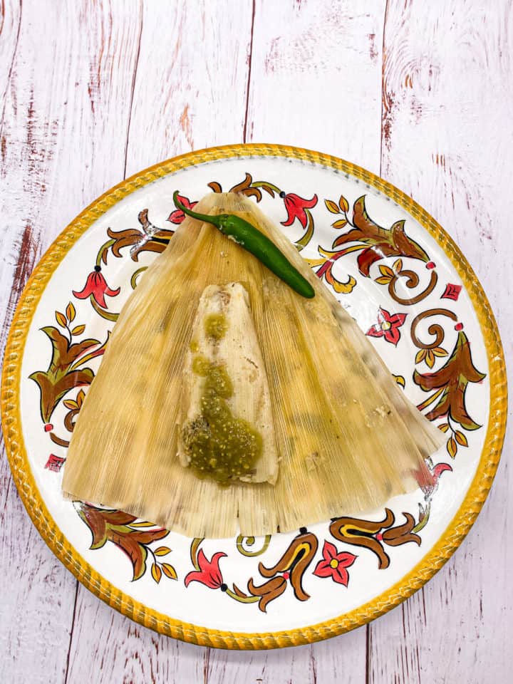 These Instant Pot Tamales are made with Maseca, chicken broth, baking powder, crisco, dried corn husk, cooked chicken, and salsa verde.
