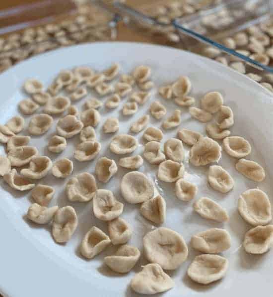 Homemade Orecchiette is made with flour, water, and salt and kneaded into a dough and shaped with your hands.
