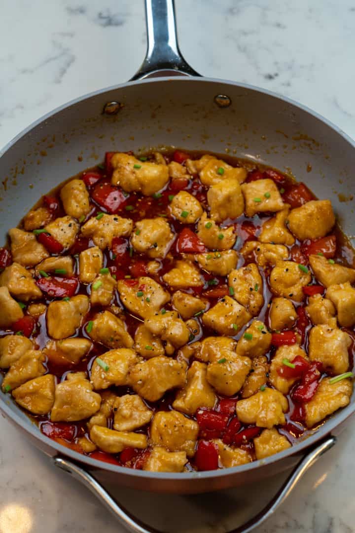 This Sweet and Sour Chicken Recipe is made with chicken, bell peppers, sugar, vinegar, ketchup, soy sauce, sesame oil, and maple syrup. 