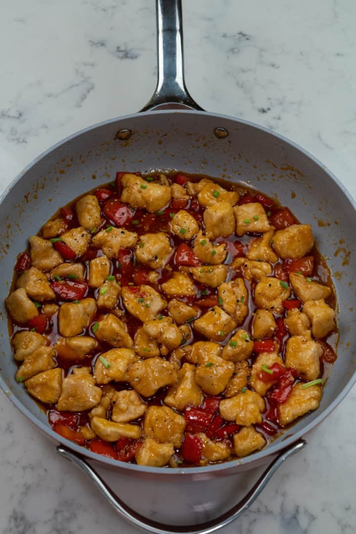 This Sweet and Sour Chicken Balls is made with chicken thighs, bell peppers, sugar, vinegar, ketchup, soy sauce, sesame oil, and maple syrup. 