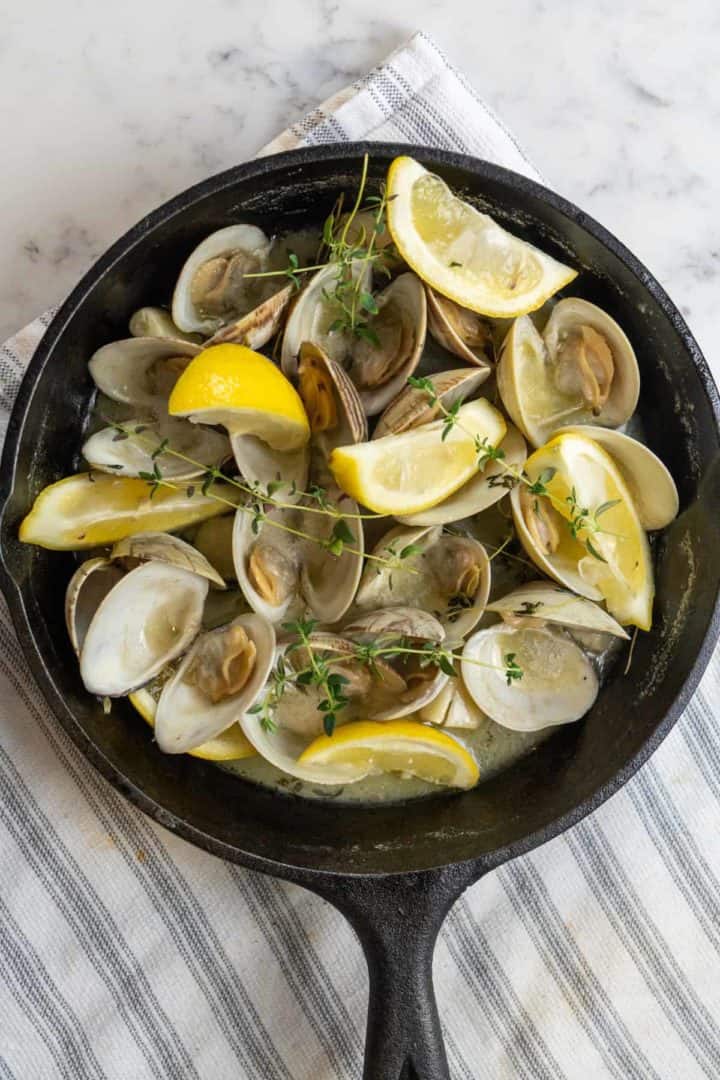 These Steamed Clams White Wine are made with littleneck clams, white wine, thyme, garlic, butter, and lemons.