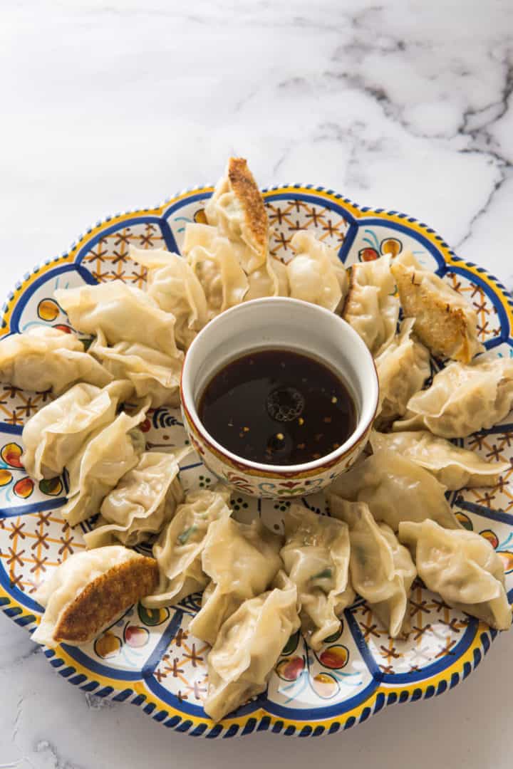 These Spicy Pork Dumplings with Sesame Ground Pork are made with ground pork, garlic, ginger, sriracha, eggs, and wonton wrappers. 