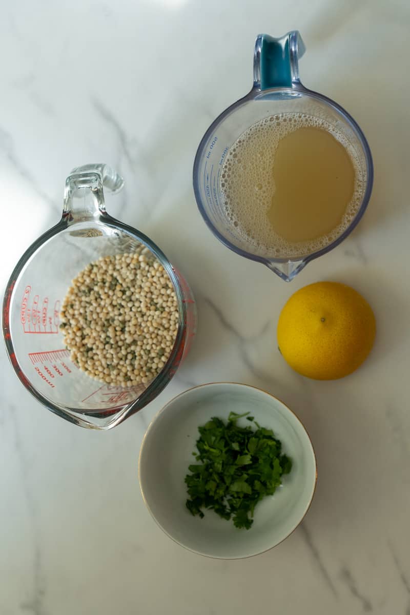 You'll only need a few simple ingredients to make this. The exact measurements are listed in the recipe card below. Here's an overview of what you'll need: Pearl Couscous
Broth
Lemon
Parsley