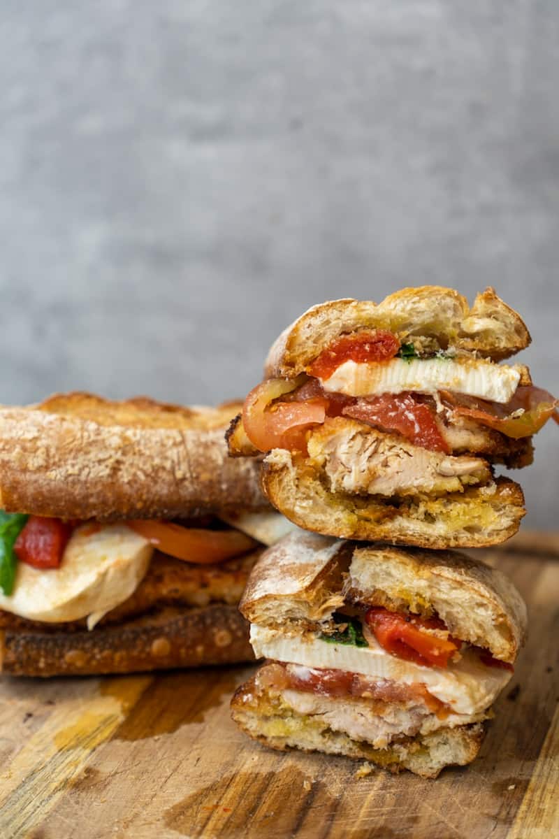 This Chicken Caprese Sandwich with Roasted Peppers is made with chicken cutlets, mozzarella, roasted peppers, vinegar, and a baguette.