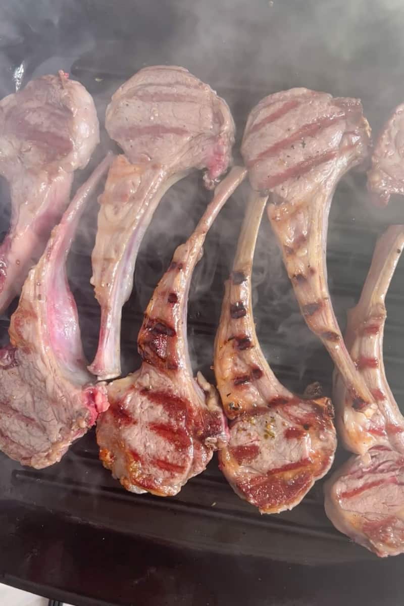 Once the grill or grill pan is heated on high heat, place the lamb chops on the grates or in the pan. Cook the chops for about 3-4 minutes per side for medium-rare doneness, or adjust the cooking time based on your preferred level of doneness. Let the lamb chops cook undisturbed on each side. 