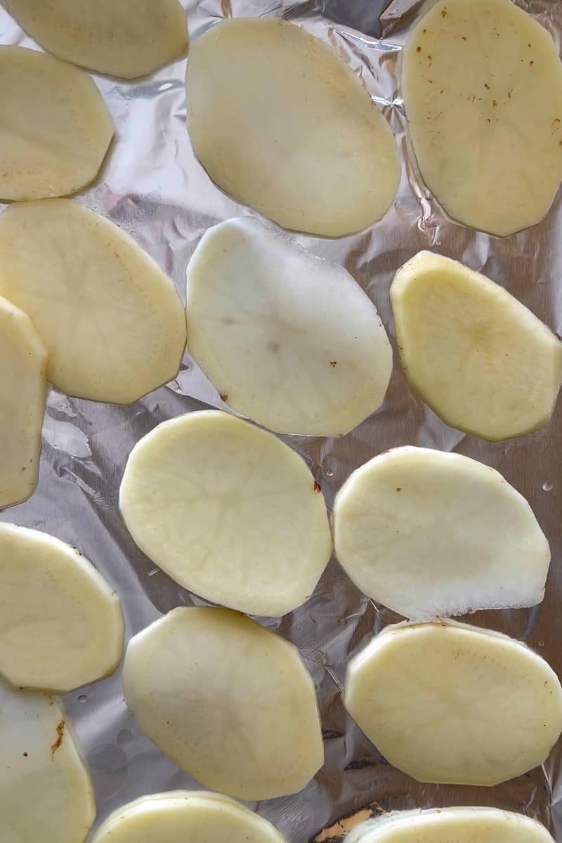 Grease the baking sheet and arrange the chips on it. You may use multiple baking sheets.