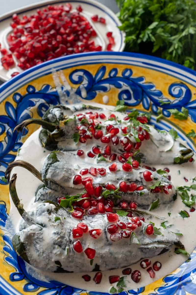 Pour the walnut sauce over the pepper. Garnish with pomegranate seeds and cilantro. Enjoy these Beef Stuffed Poblano Peppers!