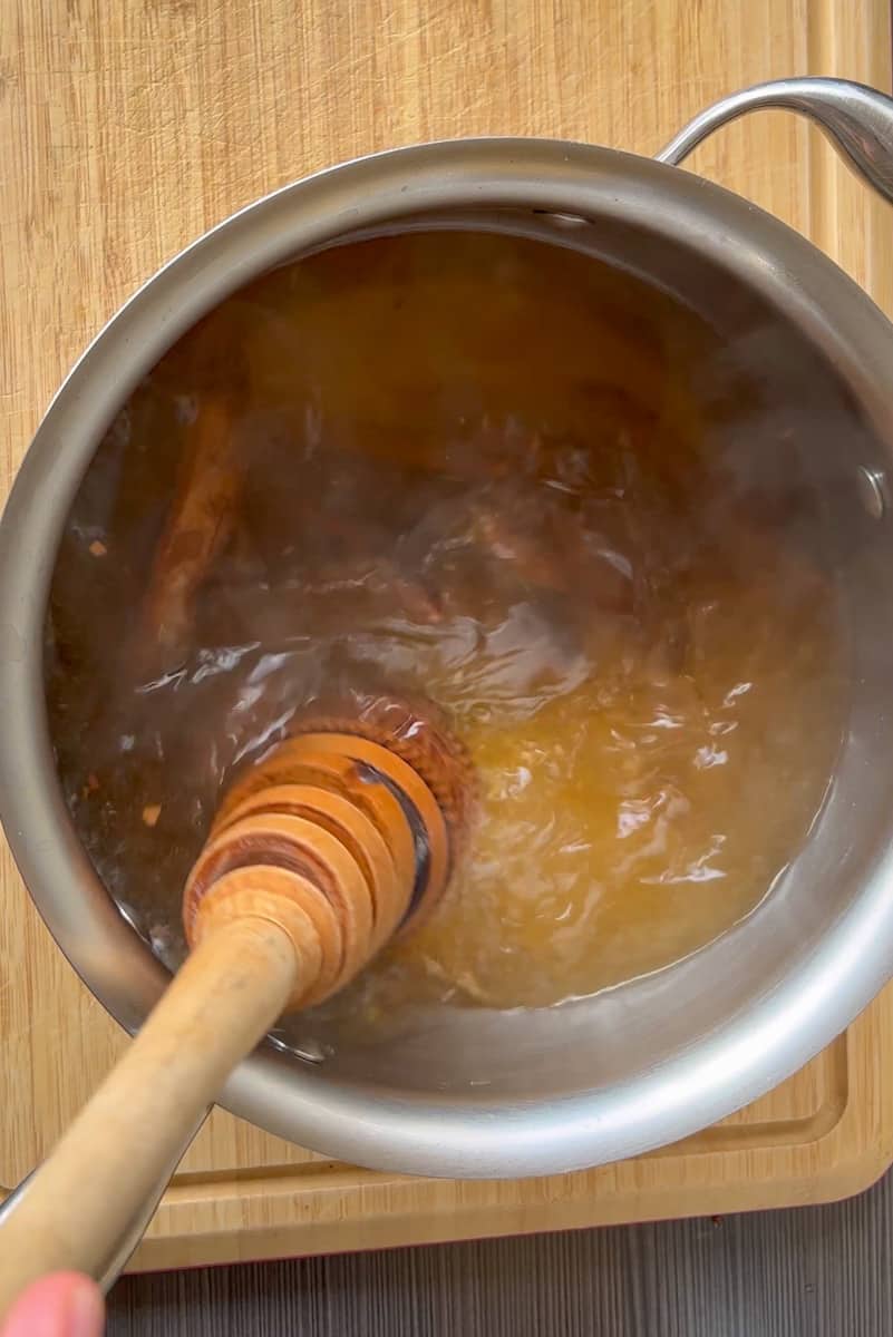 When the water comes to a boil immediately remove it from the heat and place the soft tamarind and the sugar in the water. Give it a good stir and then let it soak for about 1 hour and 30 minutes. 