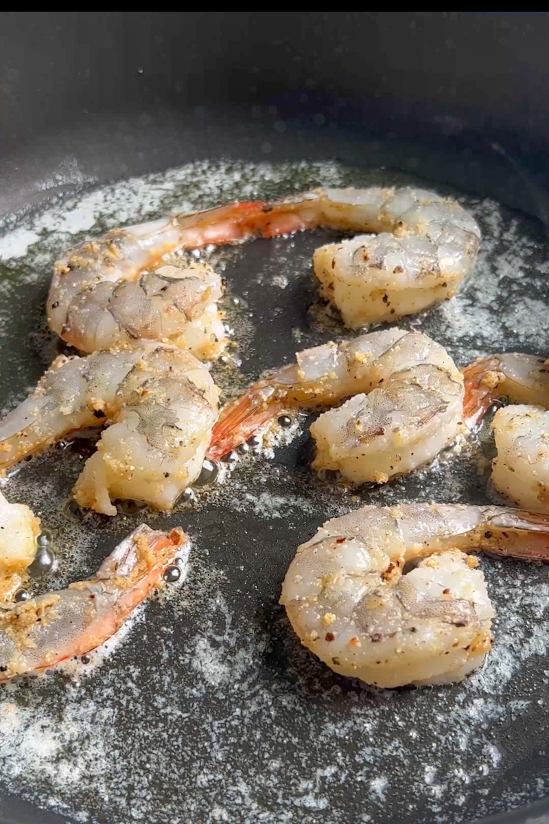 In a large bowl, add the shrimp as well as garlic powder, salt and pepper. Toss to combine. In a large skillet on medium heat, add the butter and wait for it to melt. Add the shrimp in a single layer. Cook for 2-3 minutes on each side, until pink and opaque. Remove and set aside on a plate. 